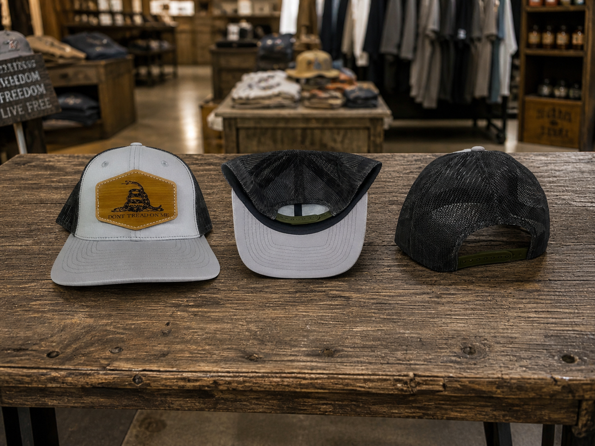 Gray front camo mesh back hat cap with brown leather Dont Tread On Me patch and adjustable snapback closure