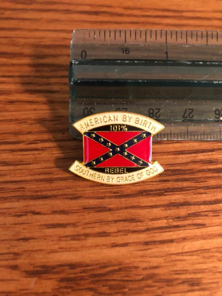 Gold lapel pin with rebel flag and "American by Birth Southern by the Grace of God" text, symbolizing southern pride and American heritage