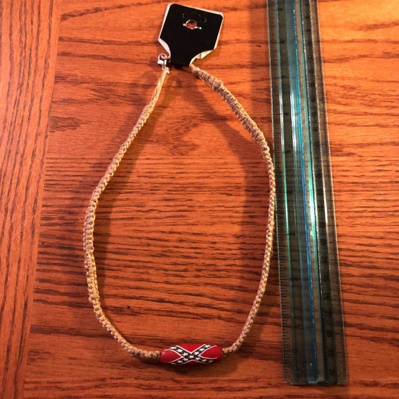 Rebel Hemp Necklace with Single Battle Flag Bead next to ruler