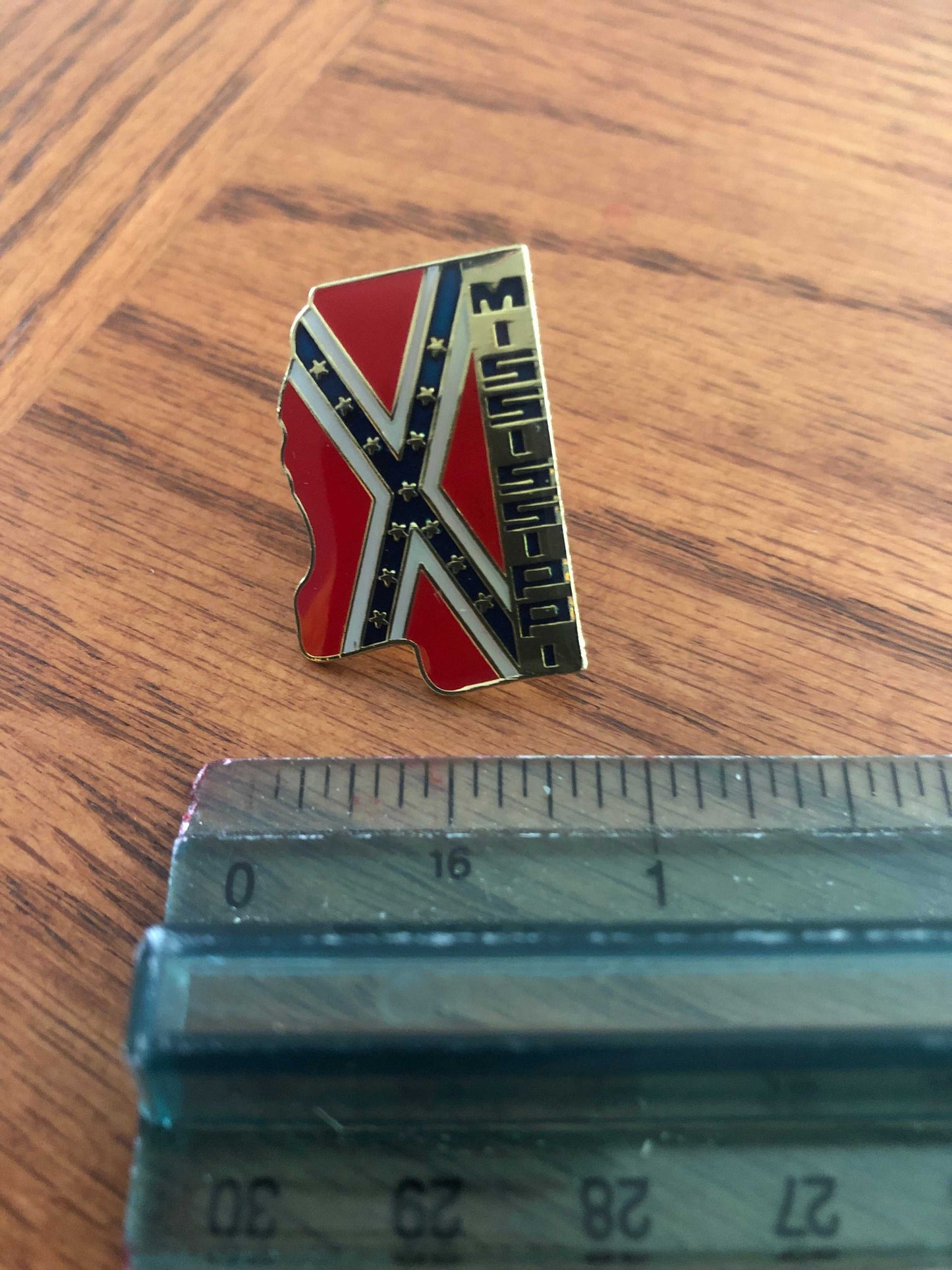 Mississippi State Rebel Battle Flag Pin next to a ruler to show size