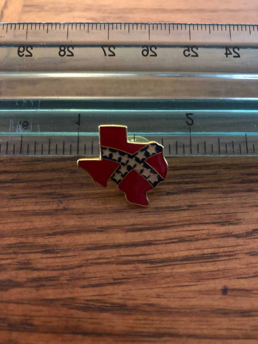 Gold Texas hat pin shaped like Texas state with secure backing on fabric background