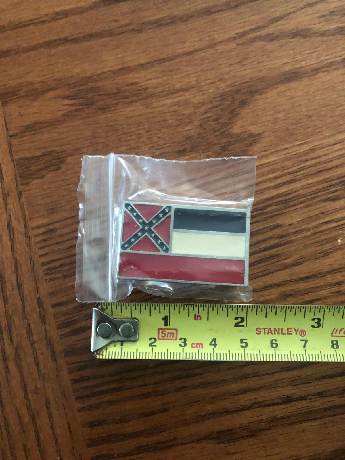 Old Mississippi State Flag Money Clip in package next to a ruler to show size