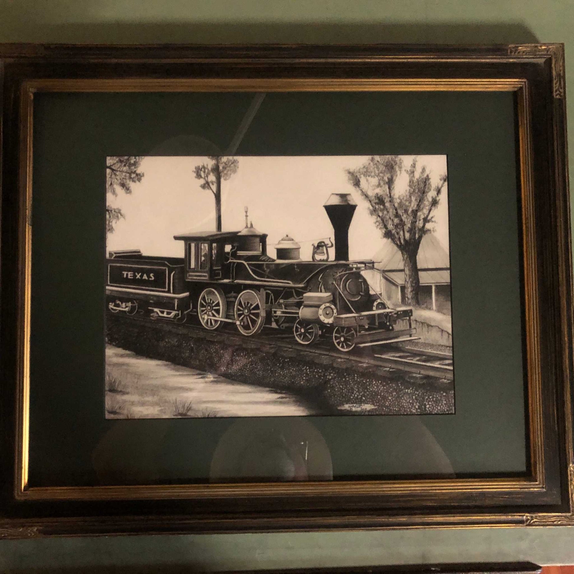 The Historic Texas Locomotive Print Unframed Signed by the Artist shown in with green matting in a wooden frame